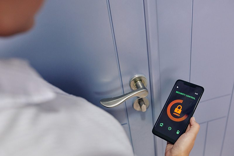 woman-using-security-control-app-XTGASKE